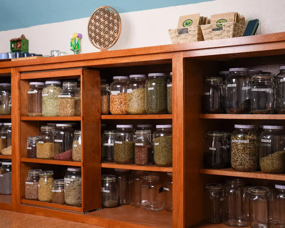 Shelves filled with loose herbs and teas in the Happyness Tea Company tea apothecary for custom tea blending