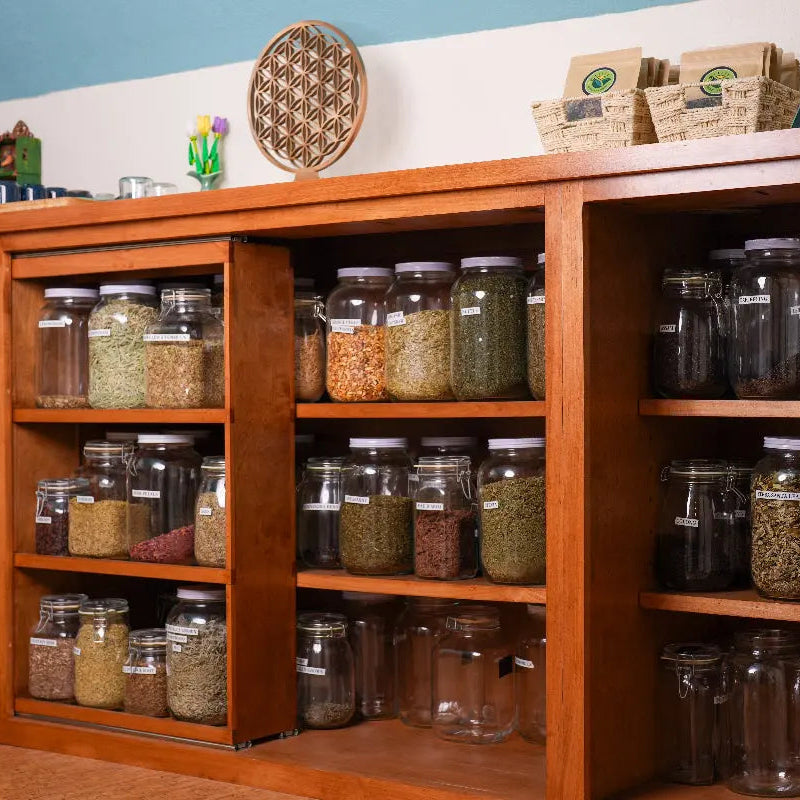 Shelves filled with loose herbs and teas in the Happyness Tea Company tea apothecary for custom tea blending