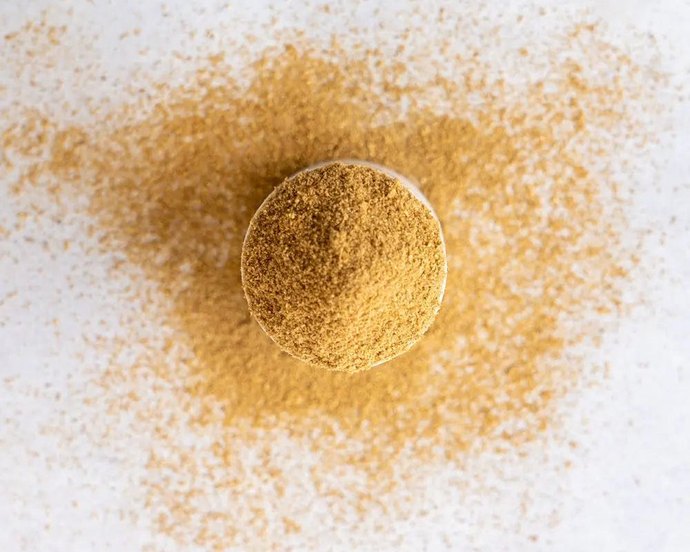 Loose Everyday Warrior spice blend showing ground fennel, cumin, and coriander seeds.