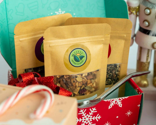 Tea sampler box featuring an assortment of four loose-leaf teas in individual packages.