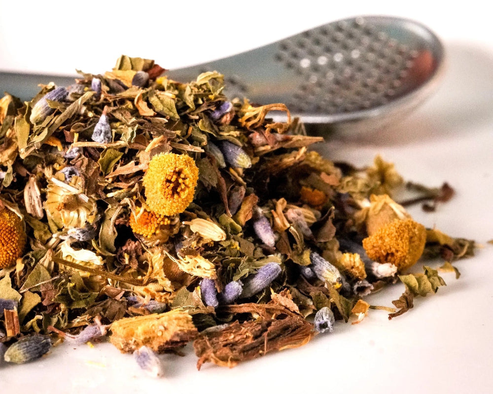 Loose Mintal Escape digestve tea showing peppermint, spearmint, fennel, ginger, chamomile flowers, lavender, and licorice root